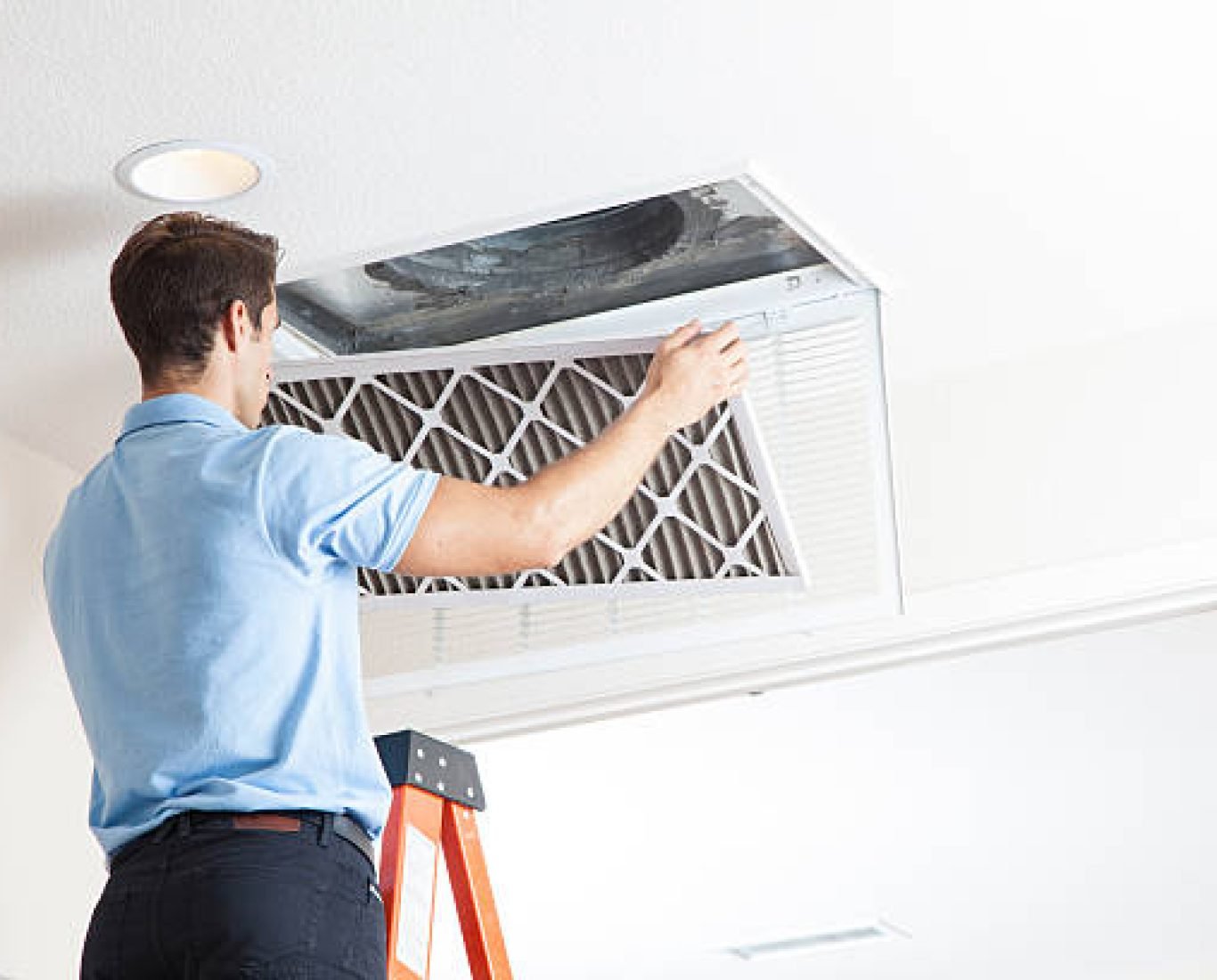 Man cleaning air ducts in home.